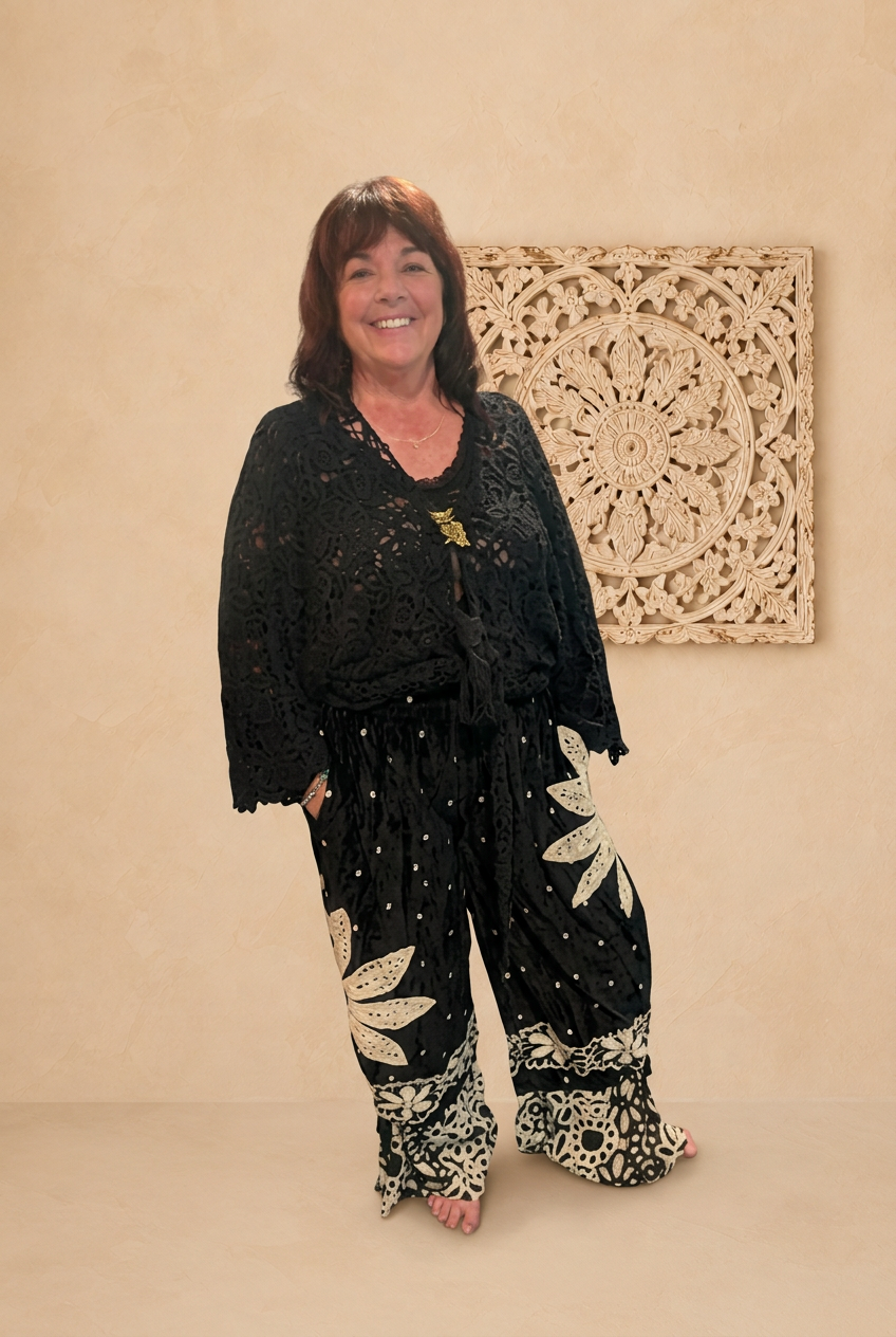 Black outfit front view with beige boho background