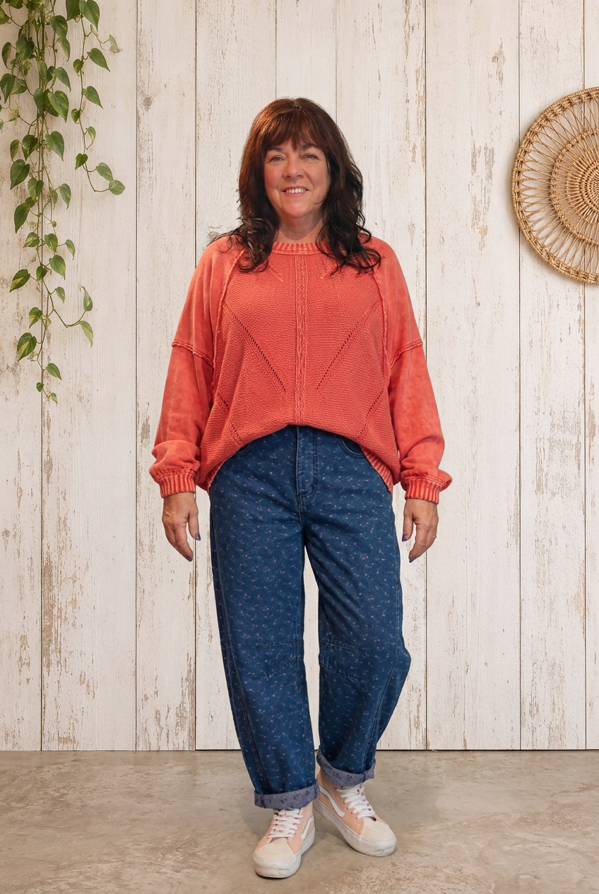 Brunette model wearing the red boho pullover and dotted denim pants