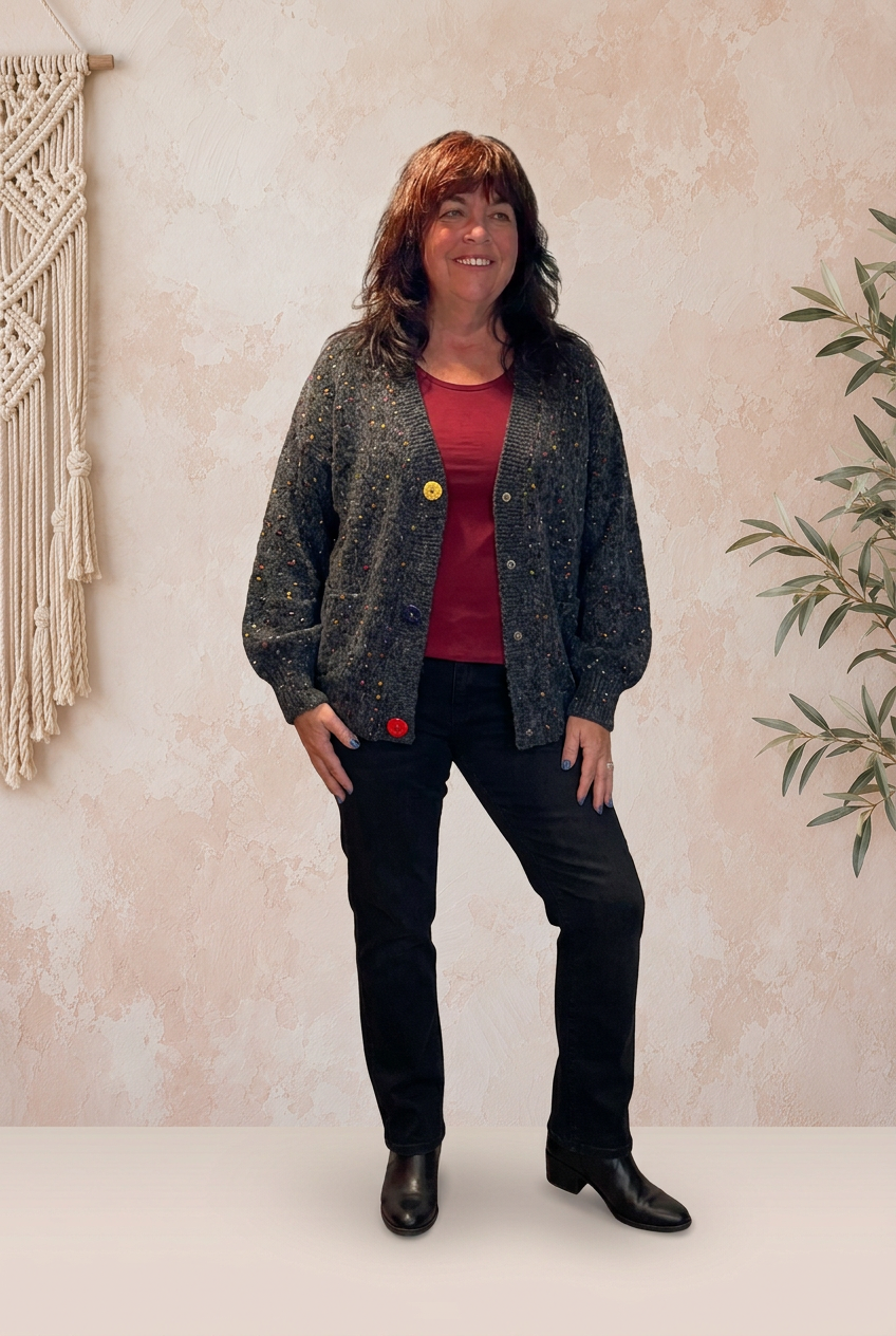 Dark-haired model in the charcoal cardigan, red top, and black jeans