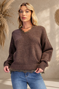 Front-view sweater preview with sunlit beige backdrop