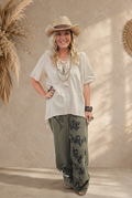 Full-length outfit with sunlit beige backdrop