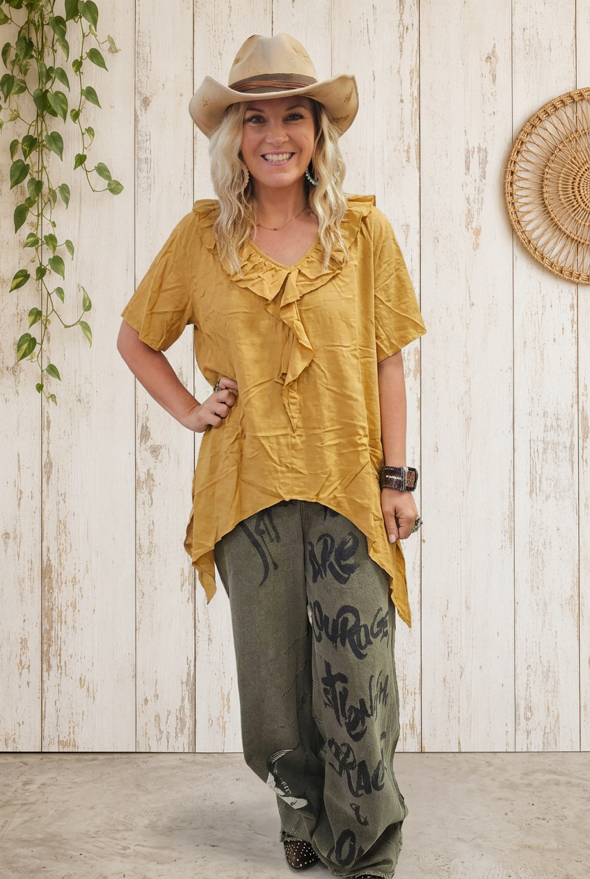 Model wearing mustard blouse