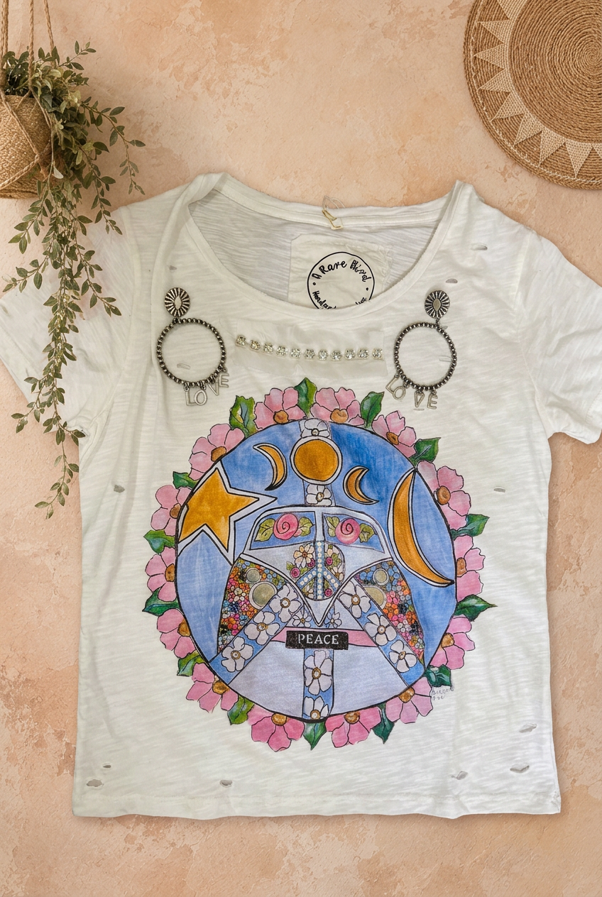 T-shirt and earrings flat-lay with beige background